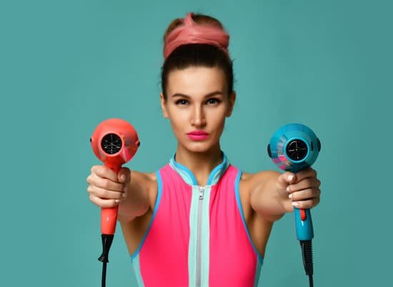 canva happy young brunette woman with hair dryer on blue mint background MADauHd 50M
