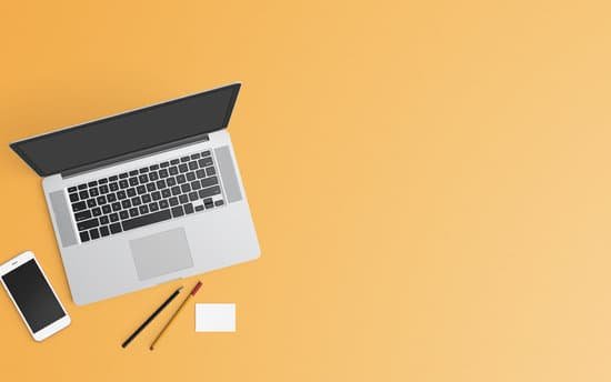canva laptop and smartphone on pastel orange background MADqJZPVSew