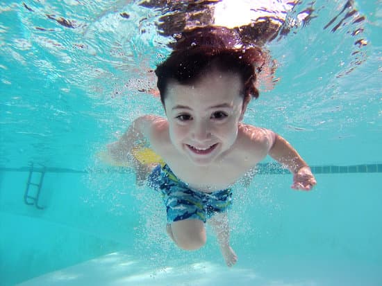 canva little boy swimming in a pool MADQ4ld F Y