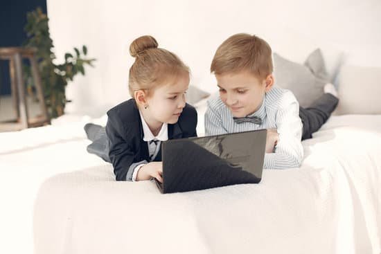 canva little children using laptop together lying on bed MAD8f5OE2z0