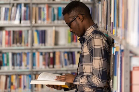 canva male college student in a library MADarP2kzbQ