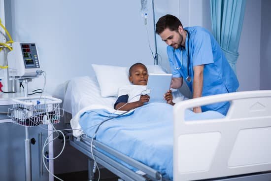 canva male nurse and patient using digital tablet in ward MADasla3Omg