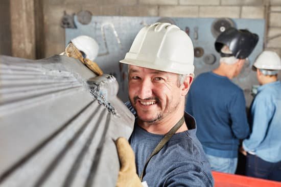 canva metal worker carrying a metal rod MAC5vsIoh4I