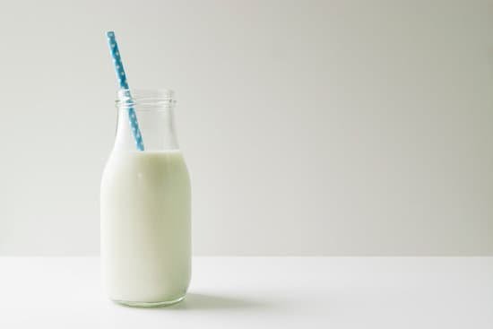 canva milk jug with milk and blue straw copy space MADaALJDyAo