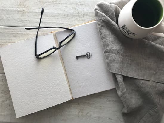 canva notebook key glasses and coffee on the desk MADQ5F2uF1o