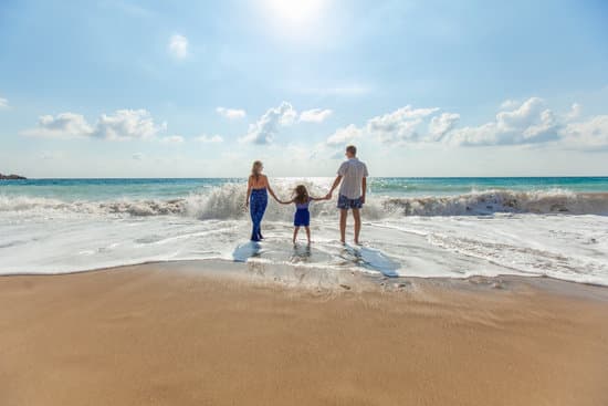 canva parents and child holding hands at the beach MADQ47nQcZs