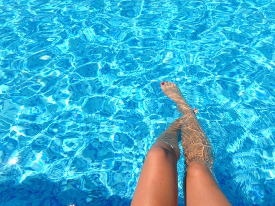canva person feet dipping on pool MADGyXXiAqc