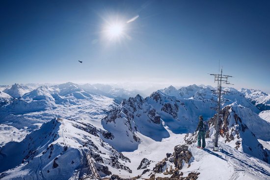 canva person on top of snow covered mountain under clear blue sky MADGyGIkhzI