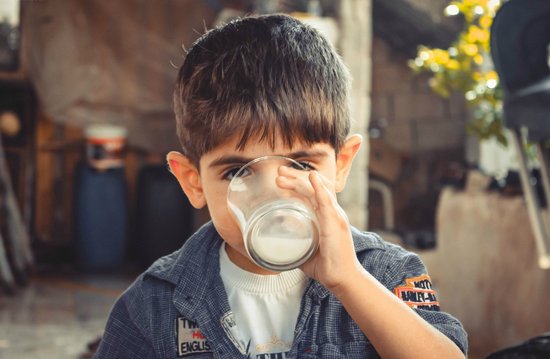 canva photo of boy drinking glass of milk MADGv3GaPFc