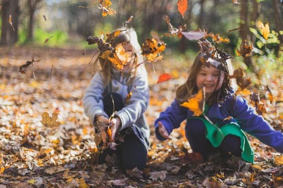 canva photo of children playing with dry leaves MADlIySYIlg