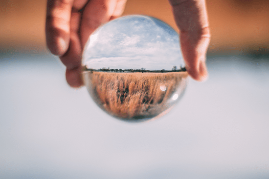 canva photo of person holding clear glass ball