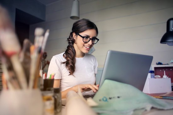 canva photo of woman using her laptop