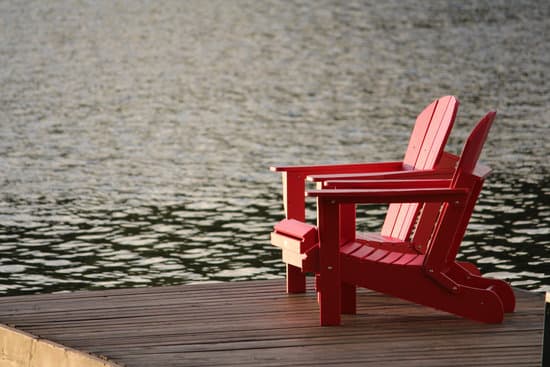 canva red wooden chairs on the pier MADQ4ydCz7s