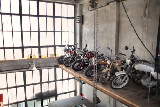 canva retro motorbikes parked in row on special platform in garage