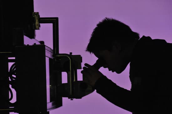 canva scientist looking through microscope MAEFj1XtXtM
