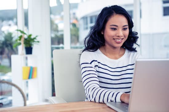 canva smiling asian woman using laptop MADaFtg1E0w