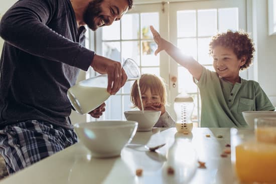 canva smiling father pouring milk in to bowls for breakfast MADQzpXTqf8