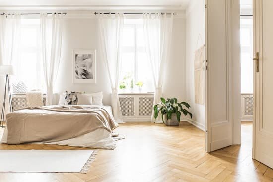 canva spacious and bright bedroom interior with beige decorations hardwood floor and a book on the window sill seat MADapPHjMec