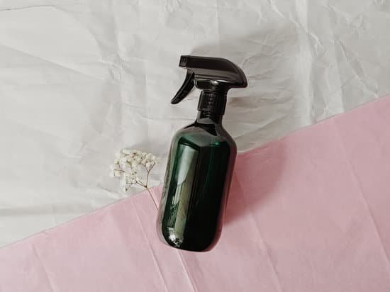 canva spray bottle beside flowers on pink and white background MAD3mtUE0Jo