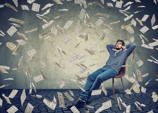 canva successful man sitting among flying money MADer739jC4
