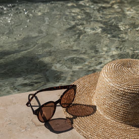 canva sunglasses and straw hat on swimming pool side MAEfOdVQwHw