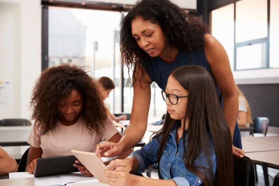 canva teacher helping high school students with technology MAChicBUbag