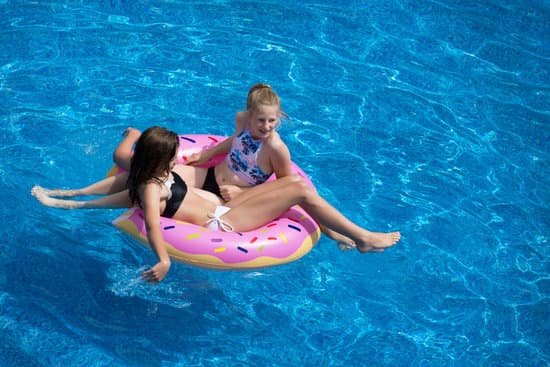 canva two girls sitting on pink doughnut pool float MADyREhCKDQ