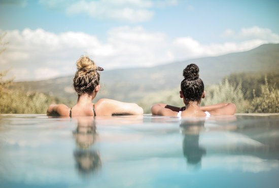 canva two women in swimming pool MADGvwMj7Qc