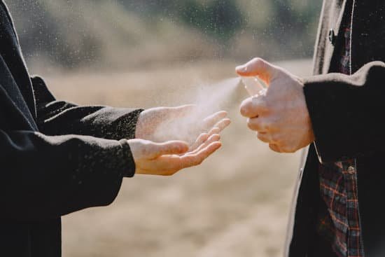 canva unrecognizable couple sanitizing hands with spray MAD nEcVjQc