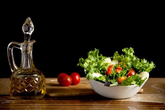 canva vitamin vegetable salad on table with bottle of oil MAEFEvrnmvI