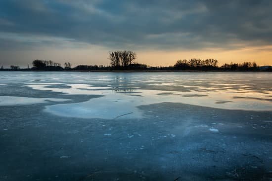 canva water puddles on the frozen lake after sunset MAEDlBfLmNs