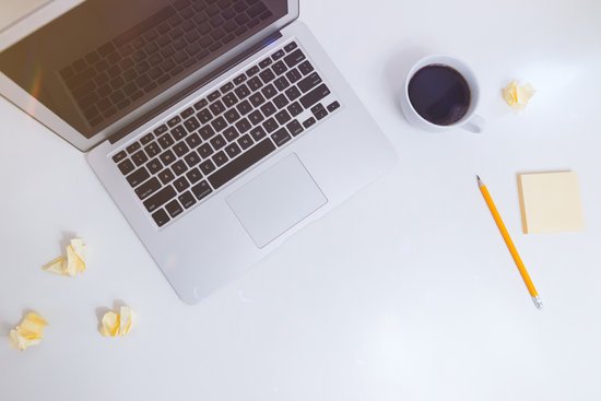 canva white desk with notes coffee and laptop