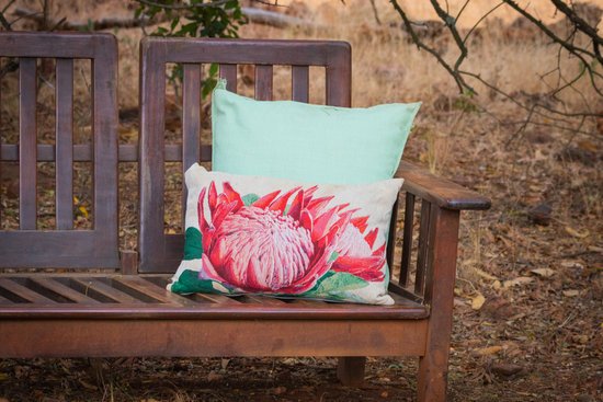 canva white pillow with lotus printed on brown wooden bench at the park MADGv2LwuSM