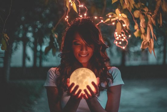 canva woman holding moon lamp MADGv Go Fc