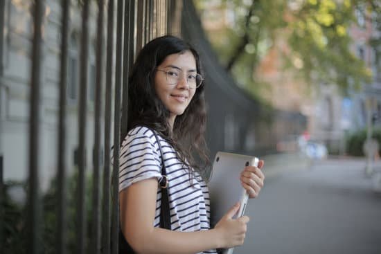 canva woman in black and white striped shirt holding laptop MAD2 CDWvHM