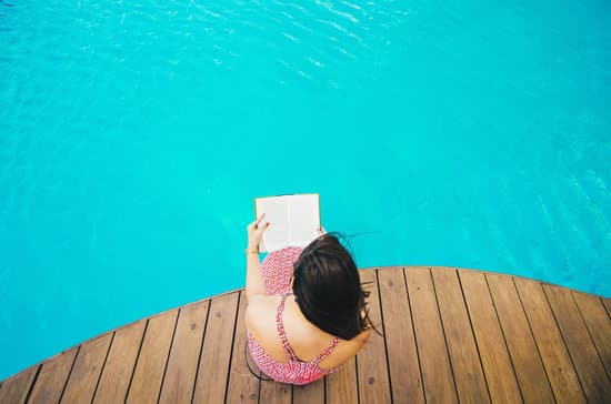canva woman reading a book by the pool MADQ5OzVwbc