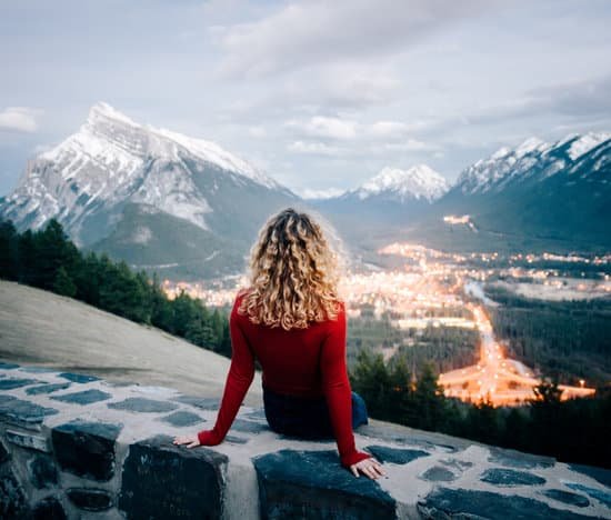 canva woman sitting overlooking city and mountains MADTkhbFaJw