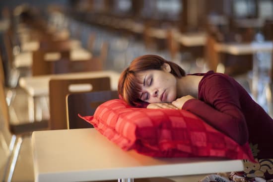 canva woman sleeping on a table with a pillow MADQ5EXmchM