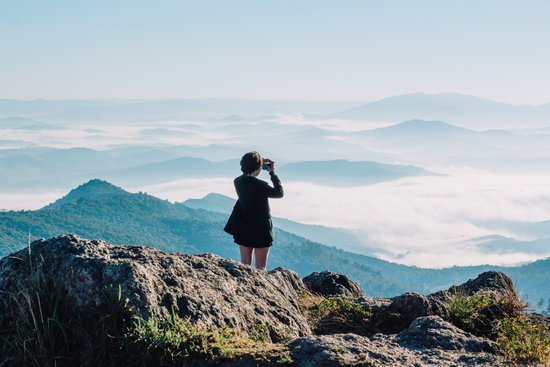 canva woman taking a picture of mountains MADGv aX0AI