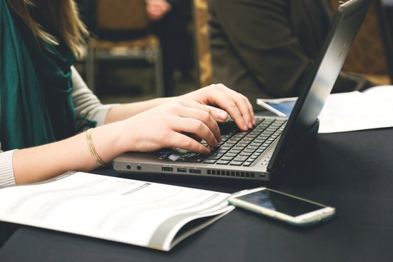 canva woman typing on laptop