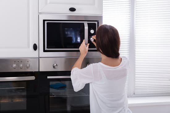 canva woman using microwave oven MADO4K9WhjA