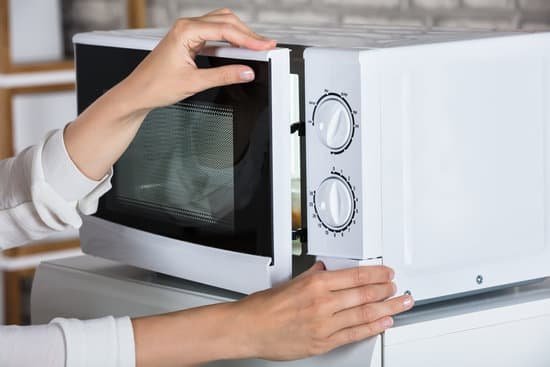 canva womans hands closing microwave oven door and preparing food MADauBtb2kE