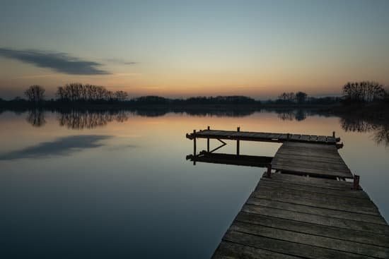 canva wooden fishing pier on lake after sunset MAD8C0BI7qE