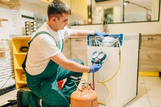 canva worker in uniform fills compressor of refrigerator MADsWkpzuMo