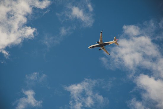 canva worms eye view of airplane flying on sky MADGwHoMYBA
