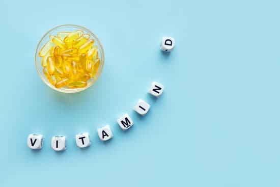 canva yellow capsules in the round glass bowl and the word vitamin d from white cubes with letters on a blue background MADesKGFjFg