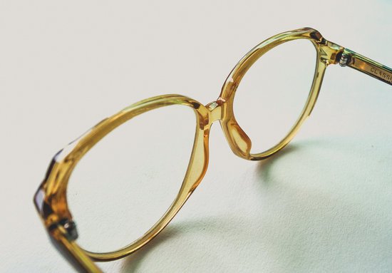 canva yellow frame eyeglasses on white surface MADGvzVA0Rk