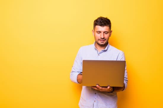 canva young handsome man with laptop on yellow background MAD2OQwS6Lw