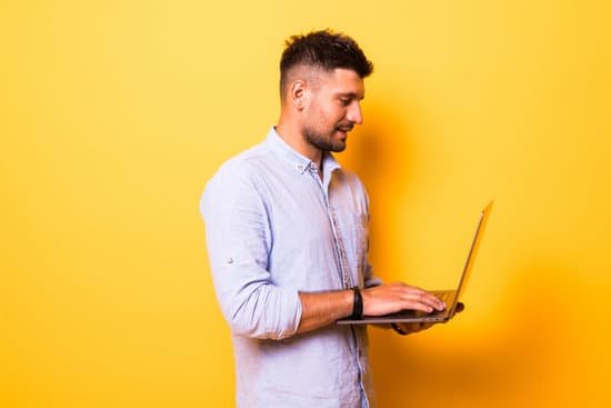 canva young handsome man with laptop on yellow background MAD2OWqvV98