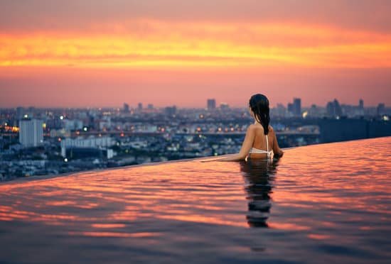 canva young woman relax in swimming pool on roof top MADkaA5y 8E